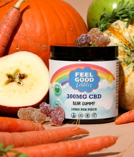 Colorful array of fresh vegetables and fruits surrounding a jar of CBD bear gummies labeled "300MG CBD."
