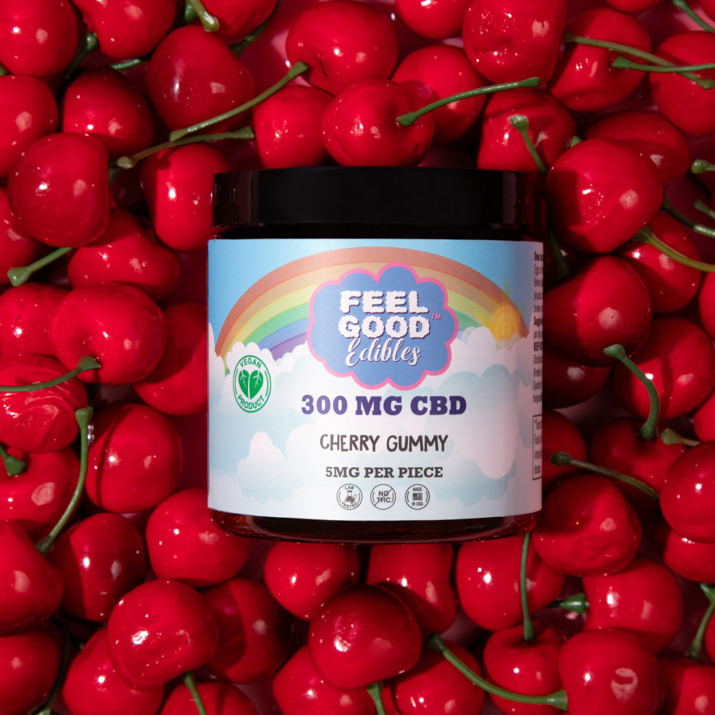 Cherry gummy jar placed among fresh cherries, showcasing the product for "The Gentle Lift" with CBD details.