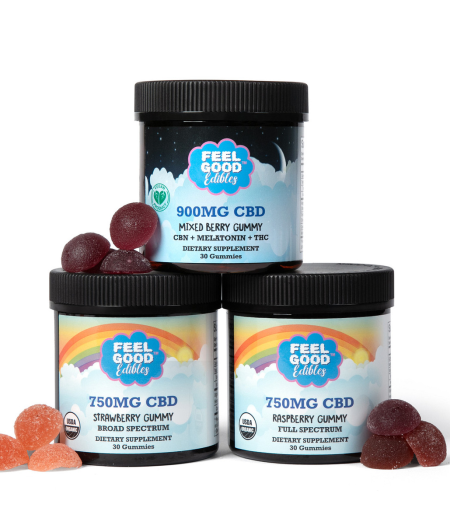 Three jars of CBD gummies labeled Mixed Berry, Strawberry, and Raspberry, with various colored gummy candies scattered around.