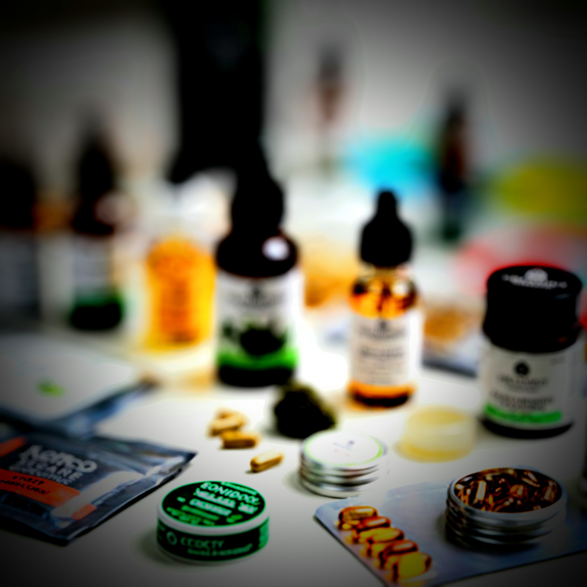 Various bottles and containers of cannabinoid products arranged on a table, showcasing different forms of supplementation.