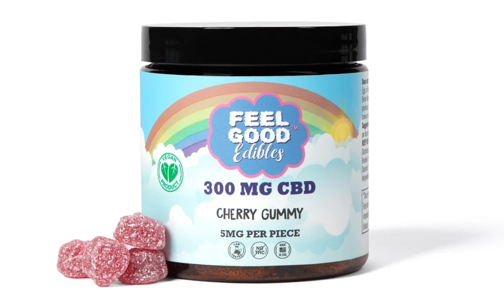 300 mg CBD cherry gummy bottle with several gummies displayed beside it, featuring a colorful label and vegan certification.