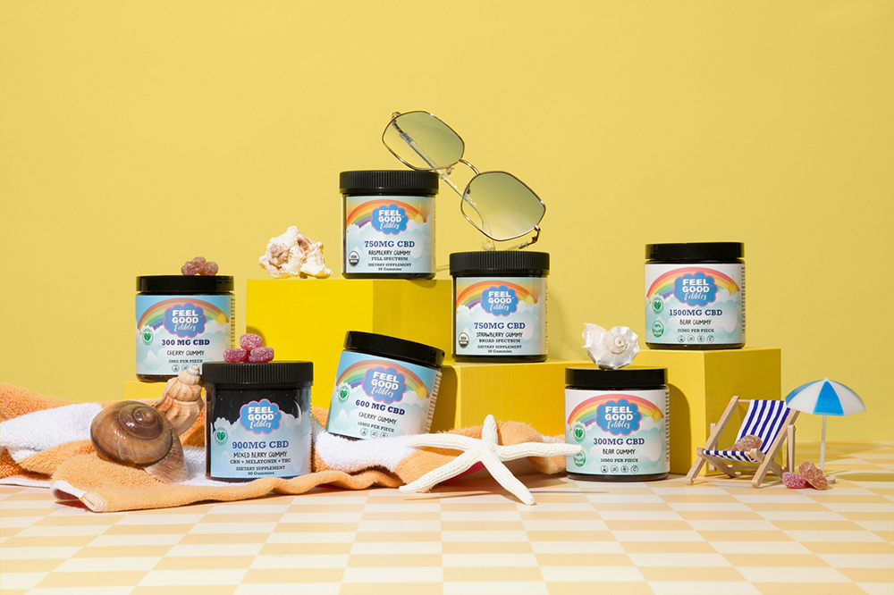 Feel Good Edibles CBD gummy collection arranged in a bright summer scene